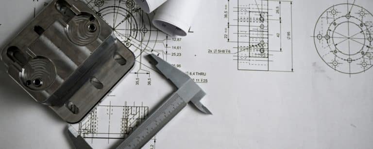 Metal,Machined,Part,Being,Measured,With,A,Caliper,,Placed,On